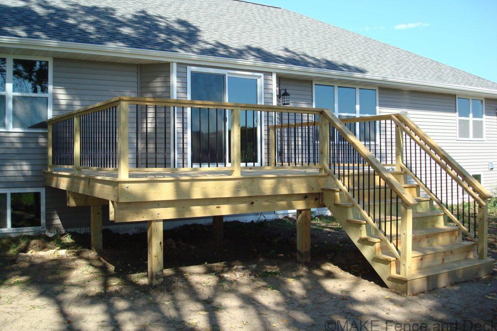 Green treated decking and rails with round metal balusters