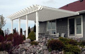 White vinyl pergola attached to house.