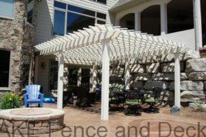 Large tan vinyl pergola with 6" posts and laths for shade.