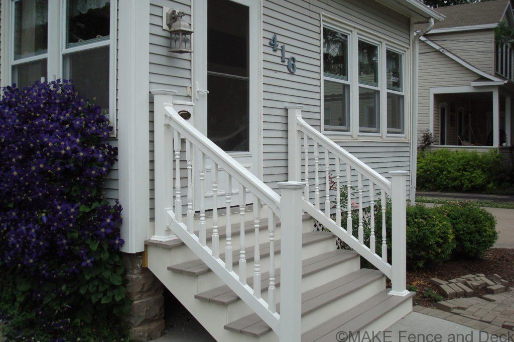 White vinyl railing consisting of Big-T top rail and 2” x 3 ½” bottom rail with 1 ½” turned style balusters.