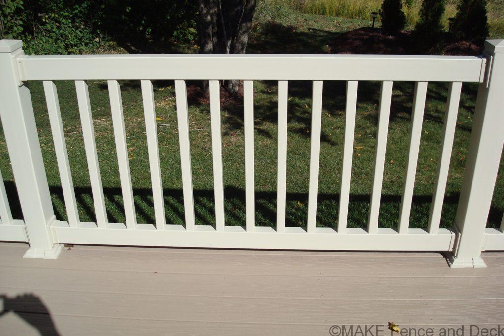 White vinyl railing consisting of 2” x 3 ½” top and bottom rail with 1 ½” square balusters.