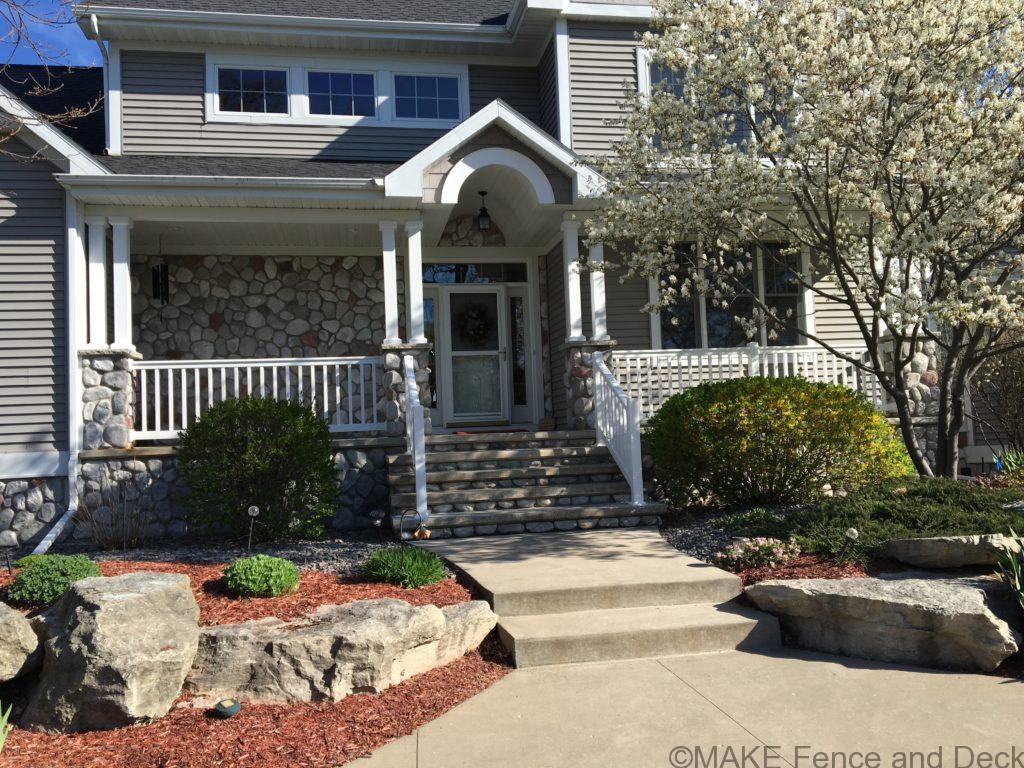 White vinyl railing consisting of Big-T top rail and 2” x 3 ½” bottom rail with 1 ½” square balusters.