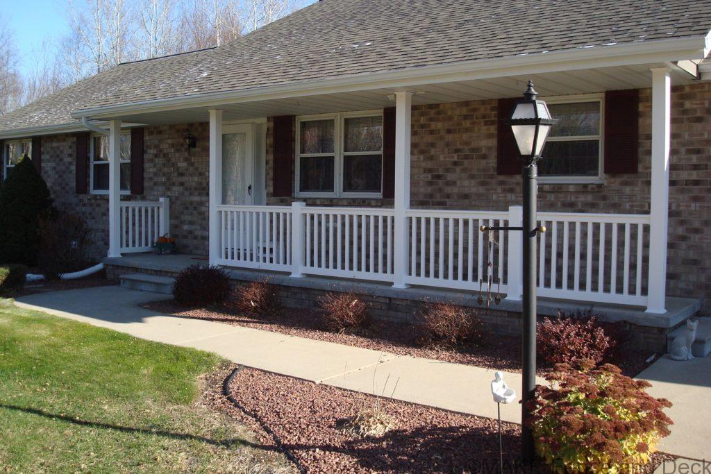 White vinyl railing consisting of Big-T top rail and 2” x 3 ½” bottom rail with 1 ½” square balusters.