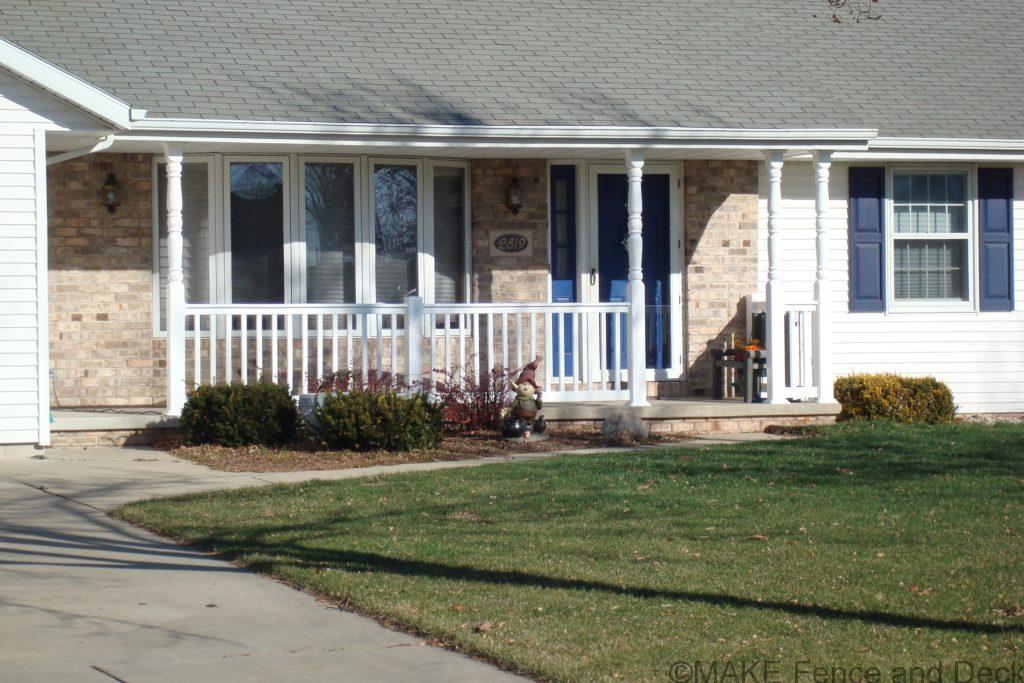 White vinyl railing consisting of Big-T top rail and 2” x 3 ½” bottom rail with 1 ½” square balusters.