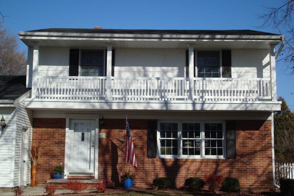 White vinyl railing consisting of Big-T top rail and 2” x 3 ½” bottom rail with 1 ½” square balusters.